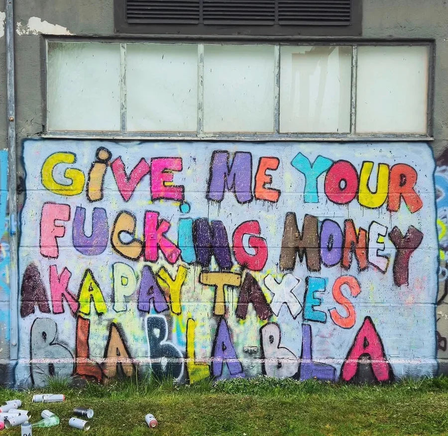 Colourful handwritten mural ending with BLA BLA BLA on a factory wall