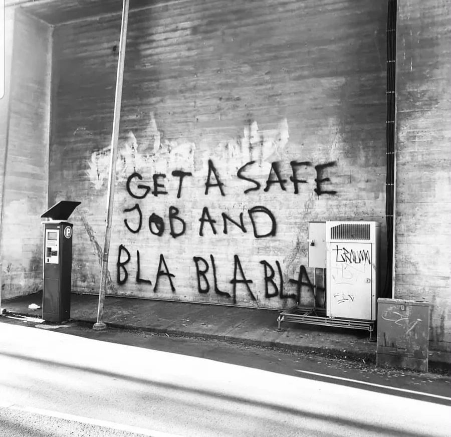 Black and white photograph of BLA BLA BLA writing on a brick wall